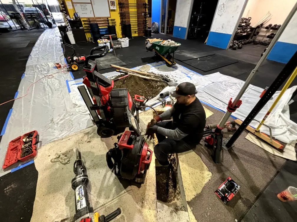 Commercial plumber performing maintenance inspection